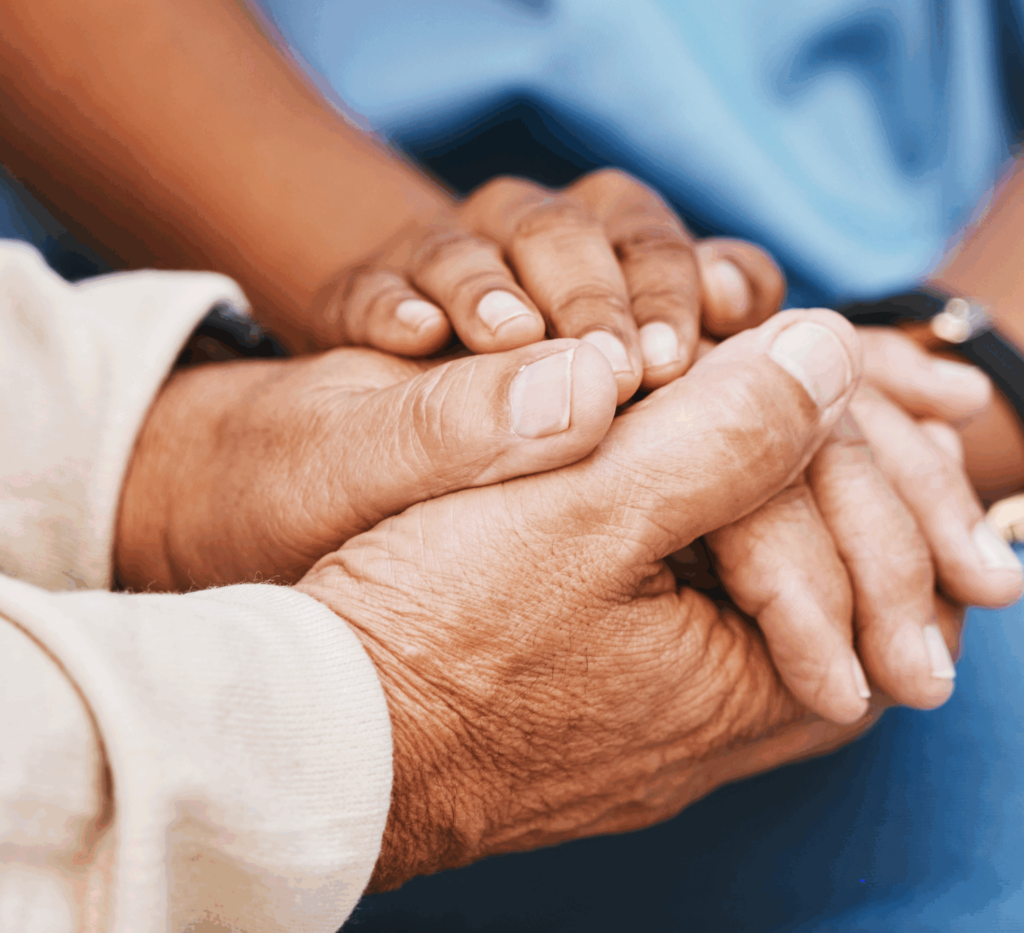 Clinical staff holding hand of patient