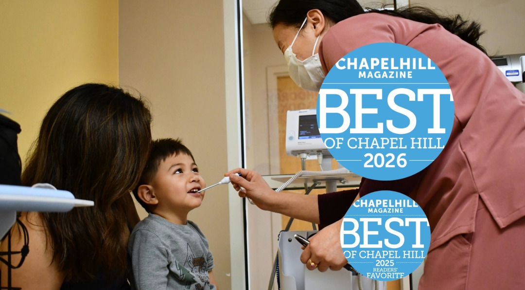 Blog header Pics-14-Best of Child receives a dental checkup from a clinician wearing a mask, with the mother beside him; blue 'Best of Chapel Hill' award badges overlay.